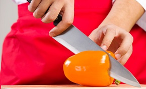 Image of a knife cutting a pepper.