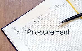 Pen and paper with the word procurement written on it.